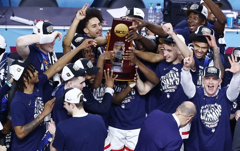 The UConn Huskies hoist the NCAA national championship trophy.