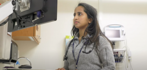 Medical student Maria Antony works on a computer in a clinical space.