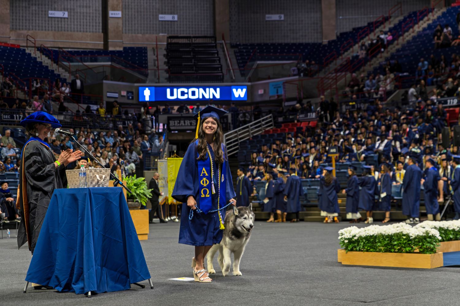 Sophie Finkelstein '24, a student handler for the Jonathans, receives her degree with Jonathan XIV. (Nick Snow/UConn Photo)