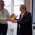 Dean Kerr receives a plaque from Department Head of Pathobiology and Veterinary Science Paulo Verardi.