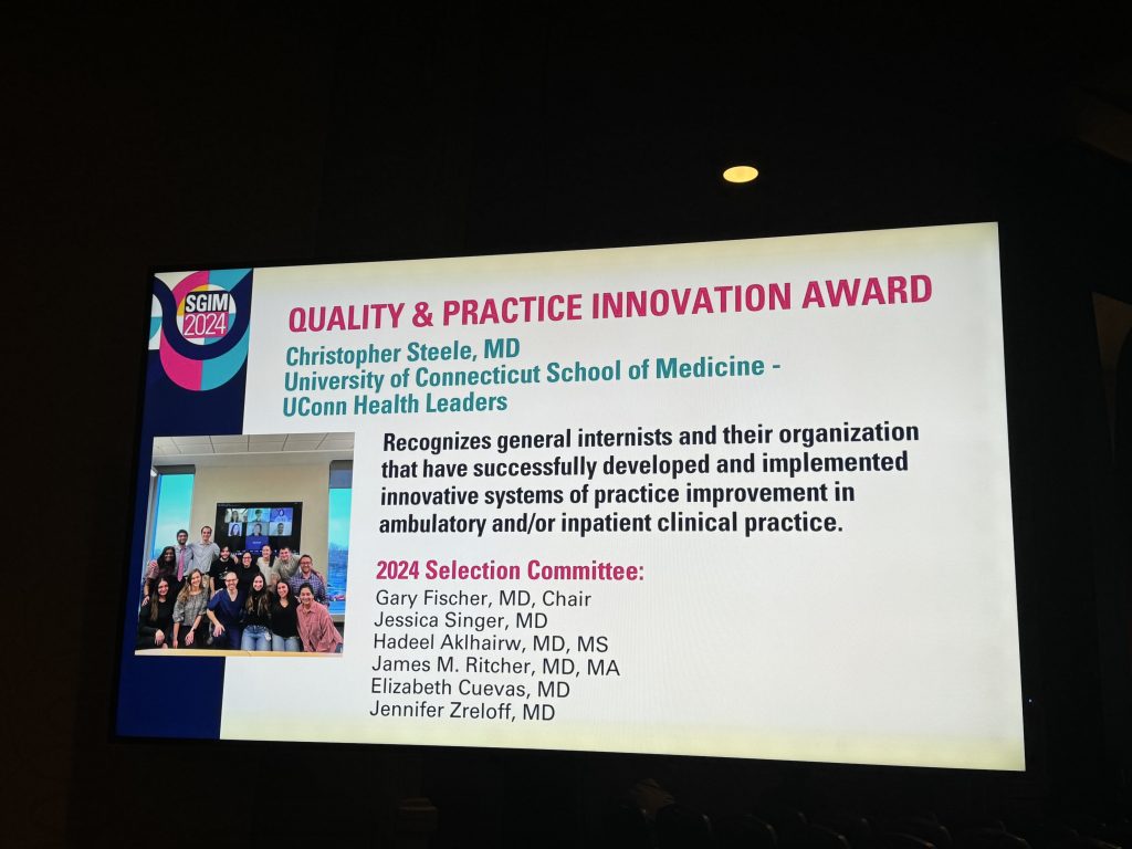 Award of UConn Health Leaders displayed on screen in Boston