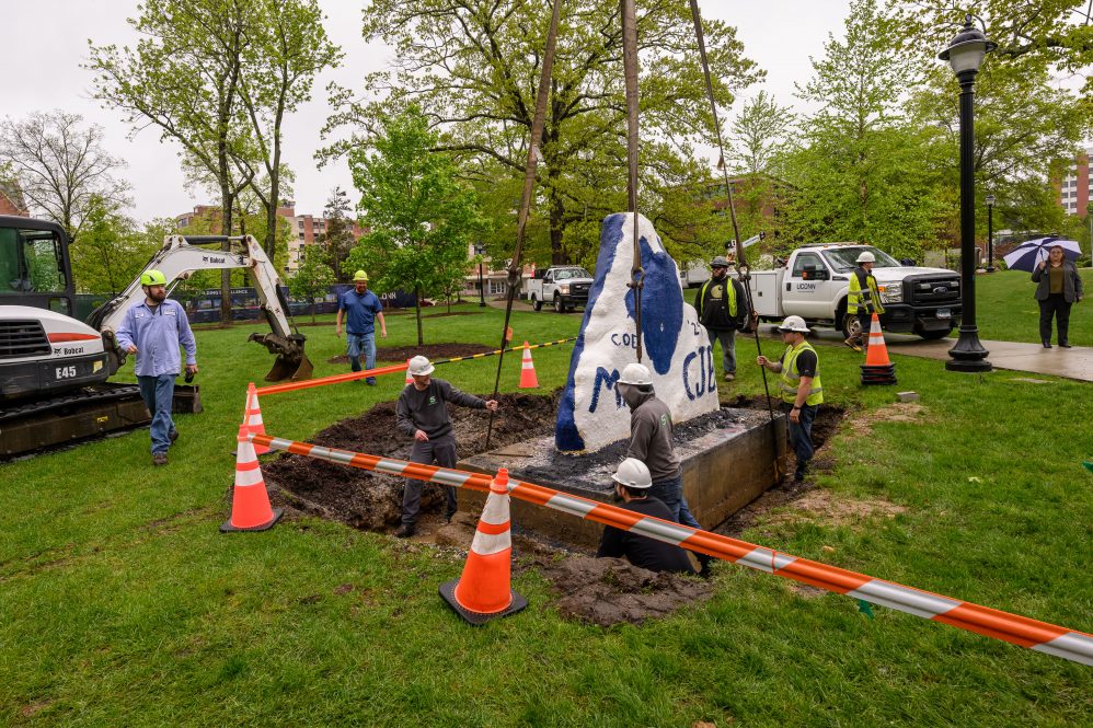 Workers use a crane to deliver the Spirit Rock to a new home at the South Campus Commons.