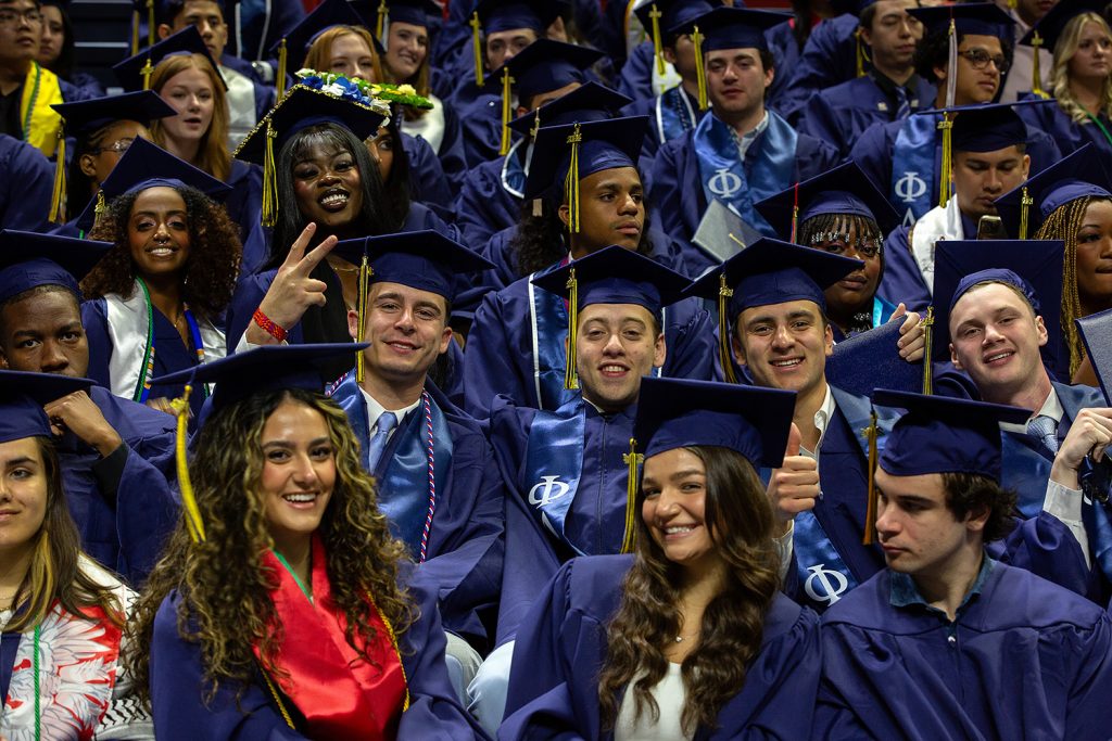 Students pose for group photo during commencement ceremony.
