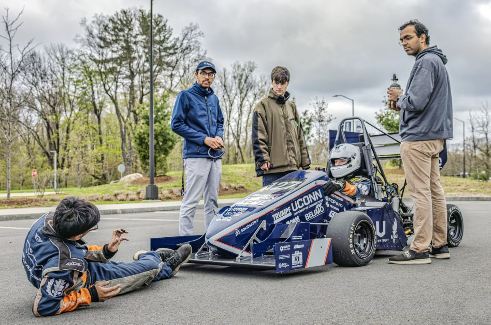 The UConn Formula SAE team examines their vehicle during the competition at Michigan International Speedway.  
