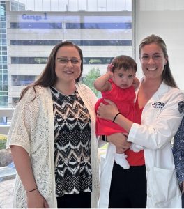 Dr. Nicole Gavin with mother and baby patients.