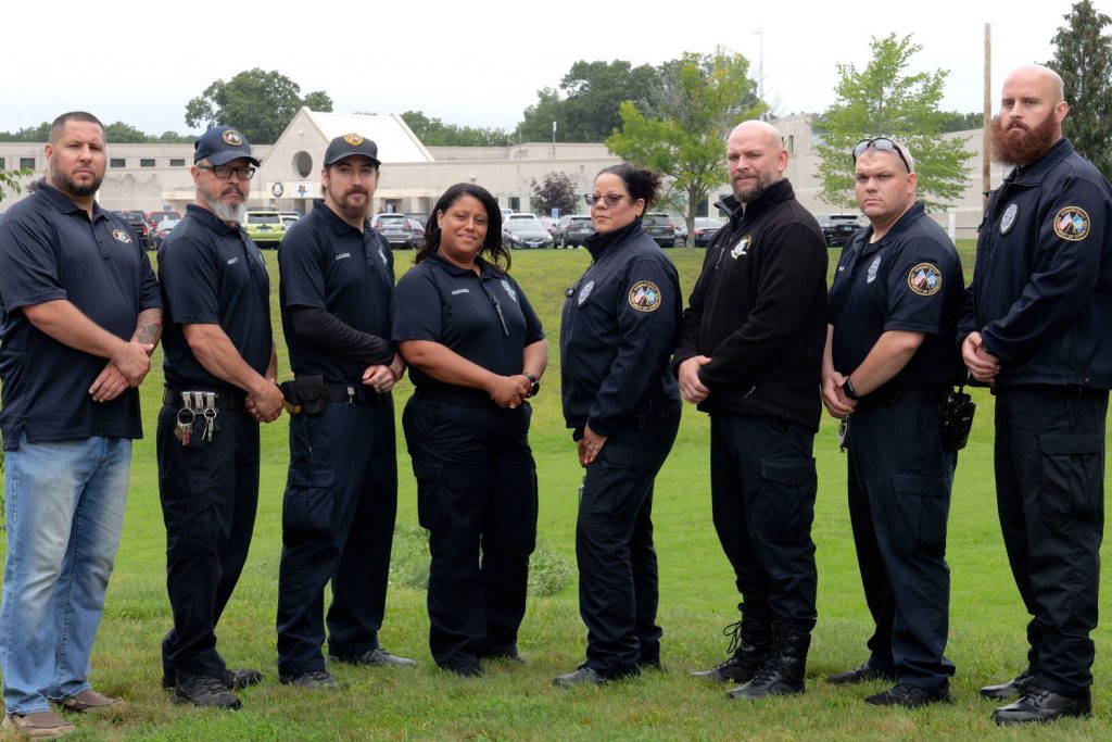 Portrait of eight correction workers outdoors