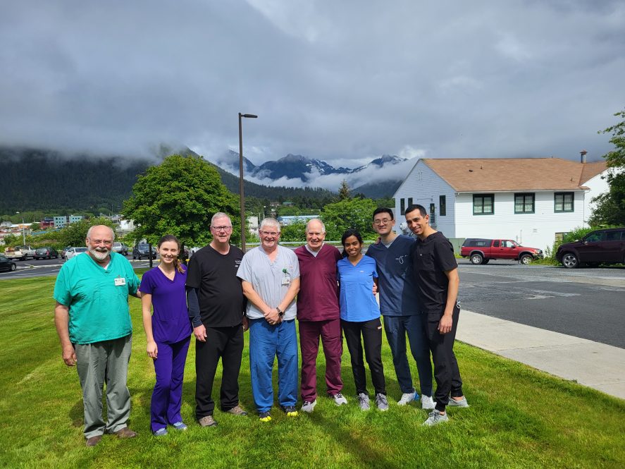 Dr. Thomas Taylor, Dr. Karolina Migus, Dr. Carl Driscoll (University of Maryland), Dr. Thomas Jordan (SouthEast Alaska Regional Health Consortium), Dr. John Agar, Dr. Shivani Survana, Dr. Paul Sim, and Dr. Greg Tao in front of the clinic in Sitka, Alaska June 2023