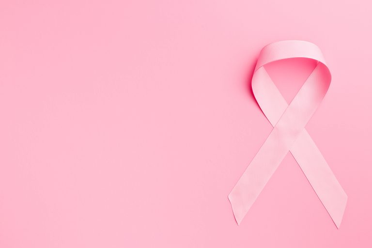 Pink ribbon breast cancer on pink background.