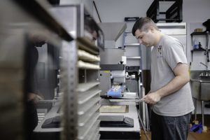 Nick Cecchini works on a batch of the Dog Bone's products.