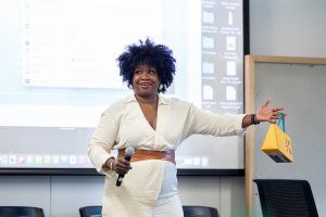 Deidre Cooper Owens gestures while delivering a keynote