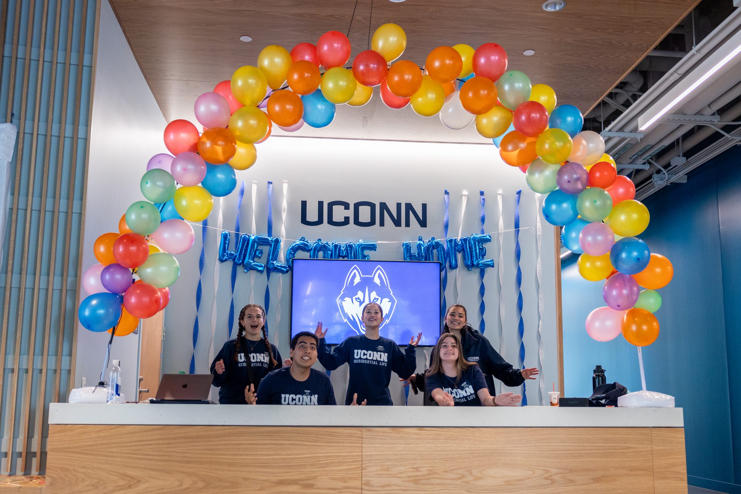 UConn resident advisors do the Husky chant in a decorated area of Connecticut Hall during move-in weekend