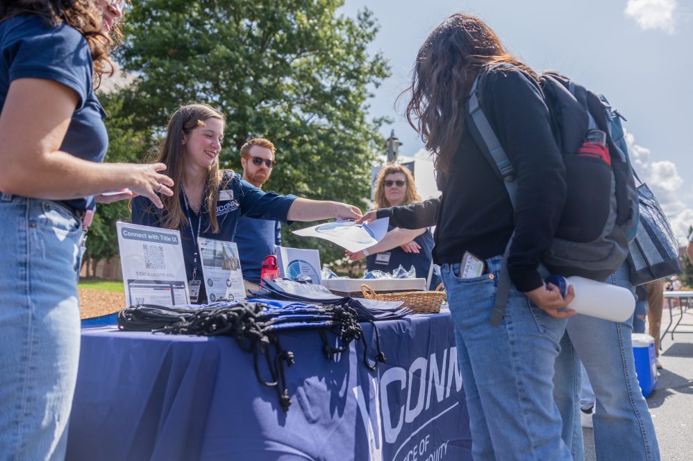 UConn students stroll through the Husky WOW welcome tents on Fairfield Way during move-in weekend for the fall 2024 semester