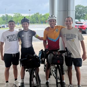 four-man portrait, two with bicycle gear