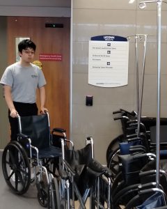 Teen volunteer retrieves a wheelchair