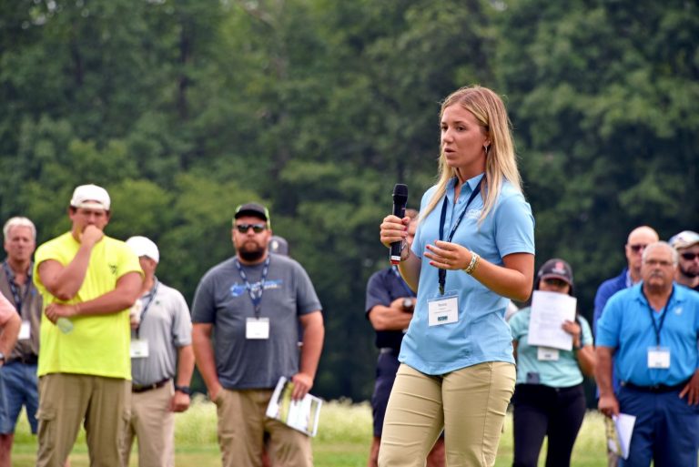 Graduate student Tessa Hospod in the Department of Plant Science and Landscape Architecture, speaks with attendees of the 2024 Turfgrass Field Day. (Jason Sheldon/UConn Photo)