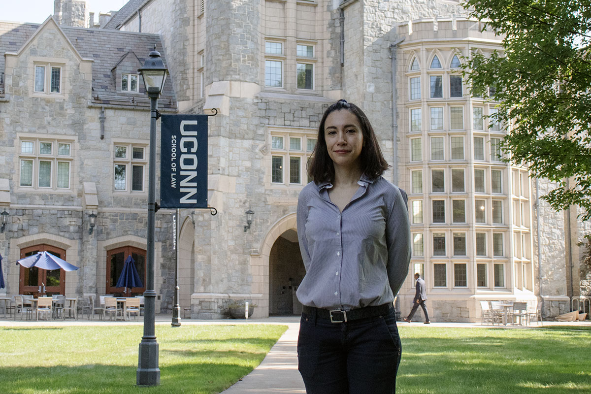 Diana Rendon Davila stands in front of the law library.