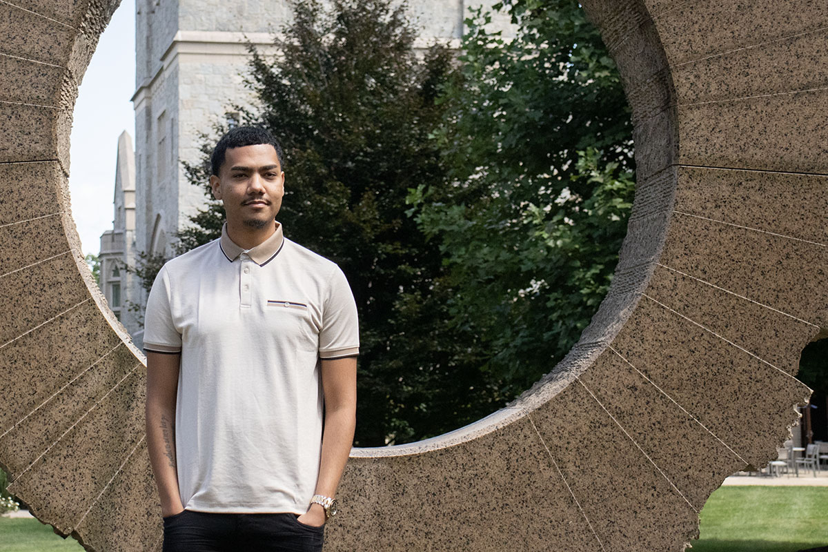 Victor Sosa stands in front of the Middle Path sculpture.