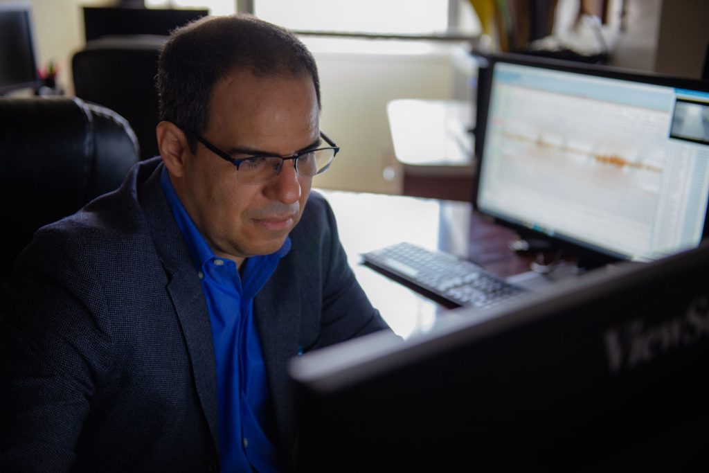 Dr. Adrian Salmon looking at a computer monitor