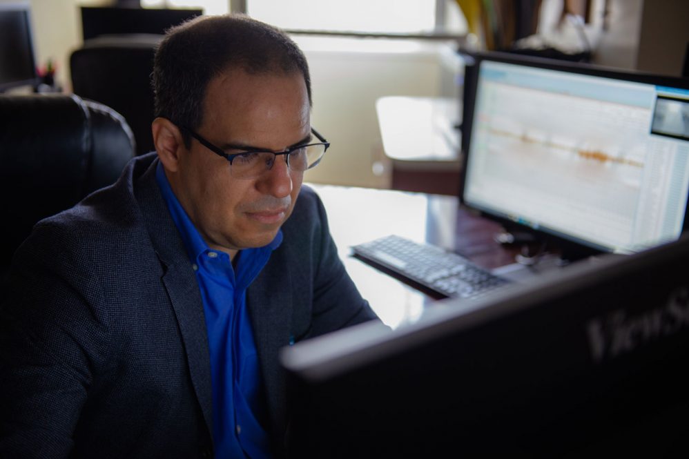 Dr. Adrian Salmon looking at a computer monitor