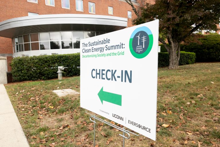 A sign for the Sustainable Clean Energy Summit sits outside the Student Union