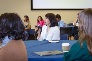 A woman asking a question to the panel.