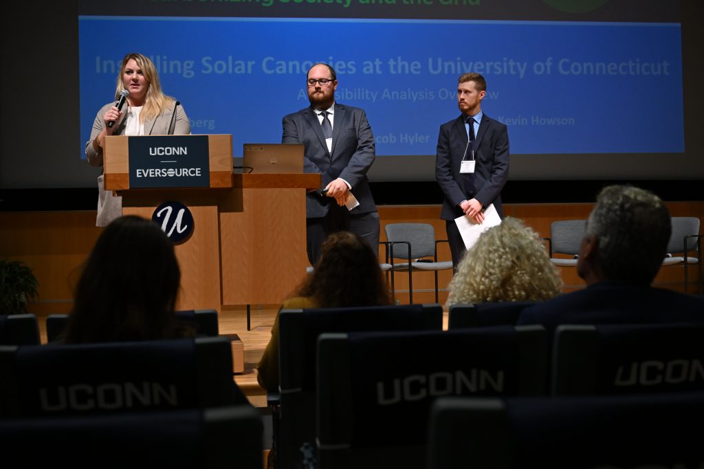 Graduate students Julie Sandberg, left, Kevin Howson and Jacob Hyler present their research on installing solar canopies on campus during "The Sustainable Clean Energy Summit:Decarbonizing Society and the Grid"