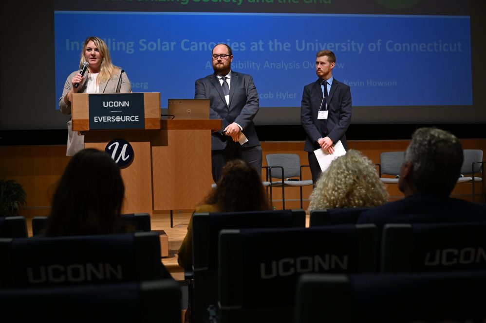 Graduate students Julie Sandberg, left, Kevin Howson and Jacob Hyler present their research on installing solar canopies on campus during 