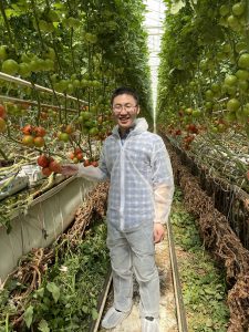 Professor Mingyu Qiao, a co-founder of Atlantic Seas Solutions, is shown at a greenhouse that grows organic fruit and vegetables.