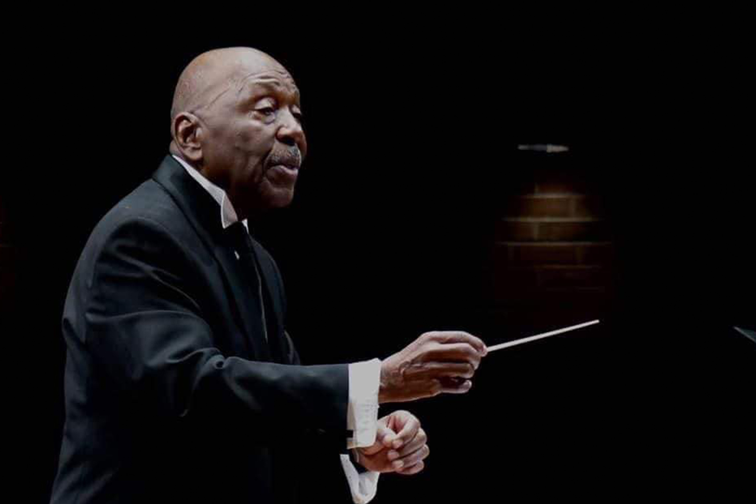 Former UConn choral director, the late Peter Bagley, directing a choir concert.