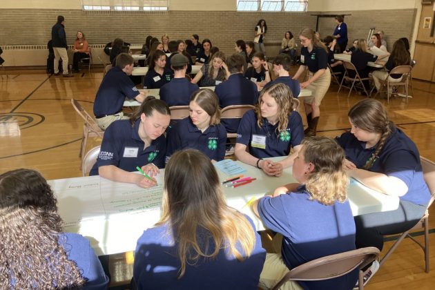 Youth at a table in a gymnasium