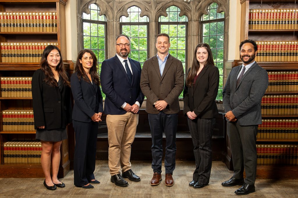 New faculty members stand in the Reading Room.