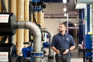 Jacob Fortin '20 (ENG) walks through the Reclaimed Water Facility in Storrs