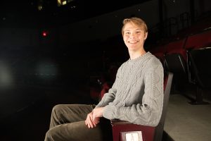 Evan Wolfgang '25 (SFA) poses for a photo in the Nafe Katter Theatre