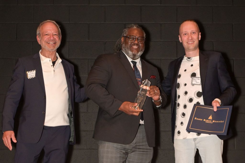 Andre Rochester, in group portrait, accepts Governor's Arts Award