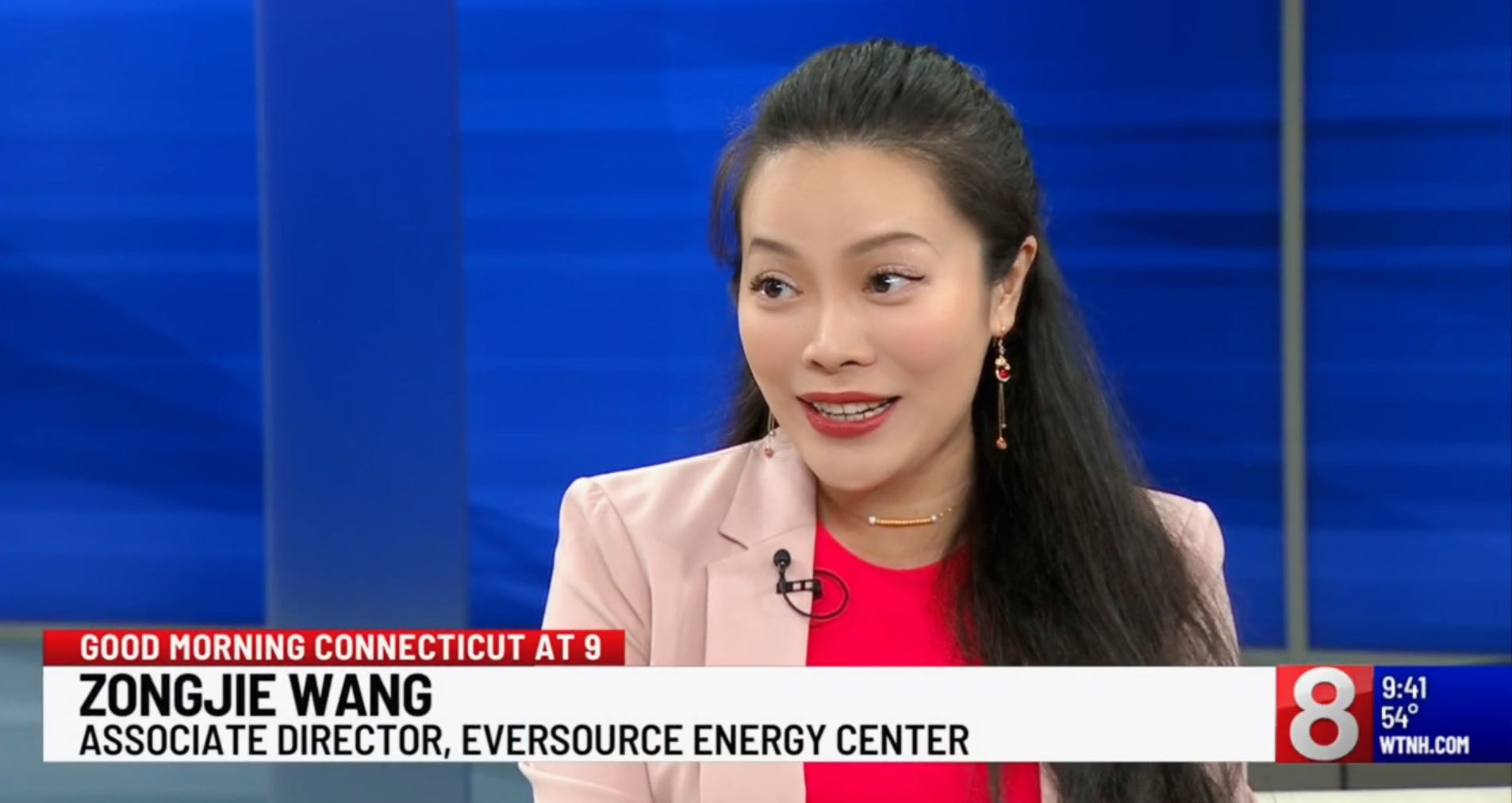 Zongjie Wang with a news chyron showing her name and title