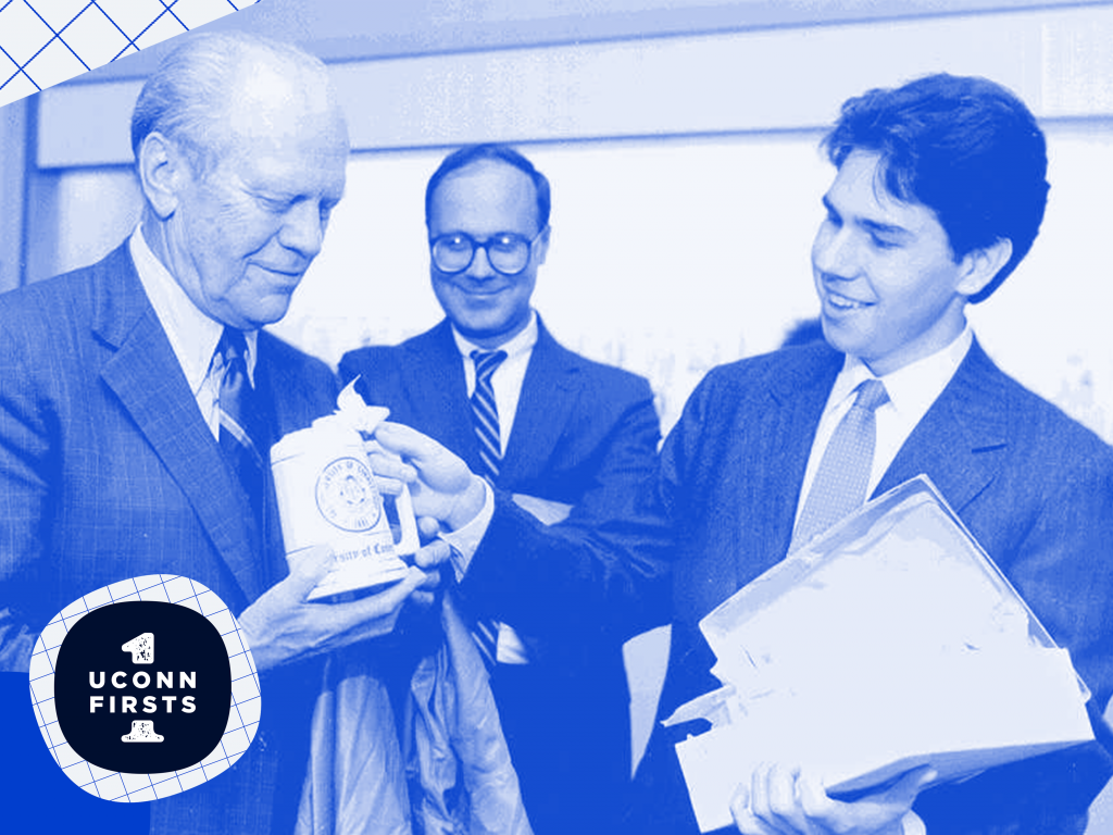 President Gerald Ford being presented with a UConn mug by University leadership