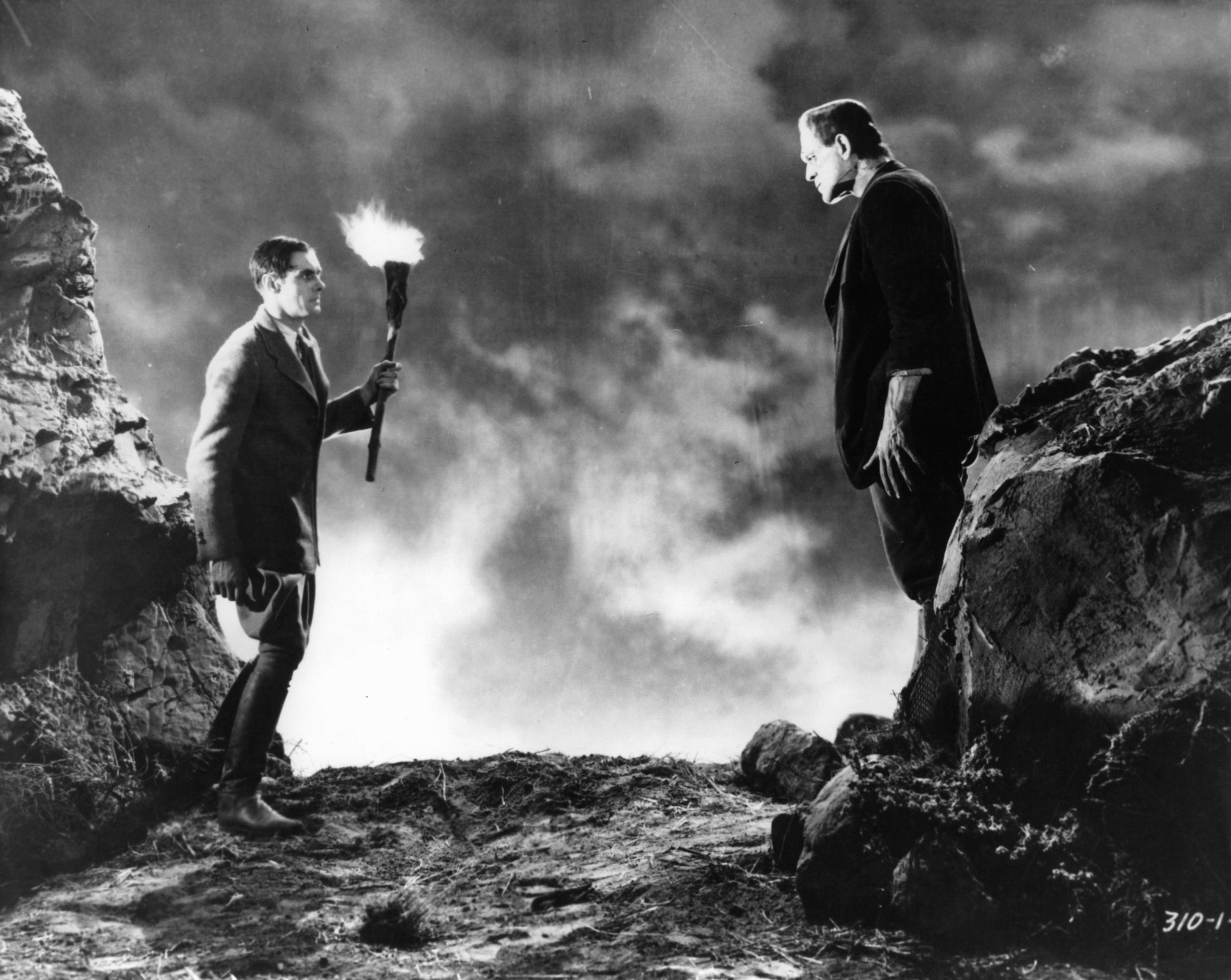 Colin Clive holding torch before the monster Boris Karloff in a scene from the film 'Frankenstein', 1931.