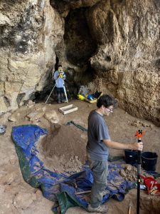 2024 test excavations in a rockshelter along the coastline near Augusta, with Department of Anthropology Graduate Student Nick Gonzalez helping to precisely capture the three-dimensional location of recovered fossils.