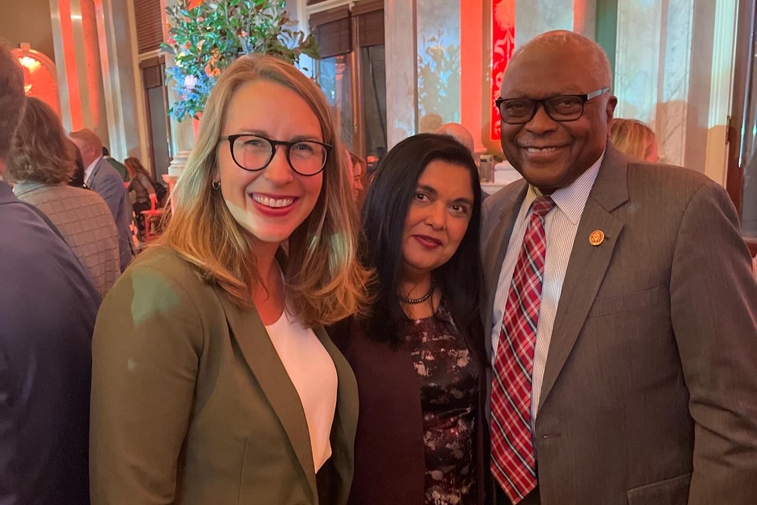 Manisha Sinha poses for a photo with Reps. Hillary Scholten of Michigan and James Clyburn of South Carolina.