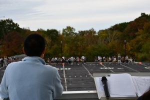 Justin McManus, director of athletic bands, looks out over a recent practice.