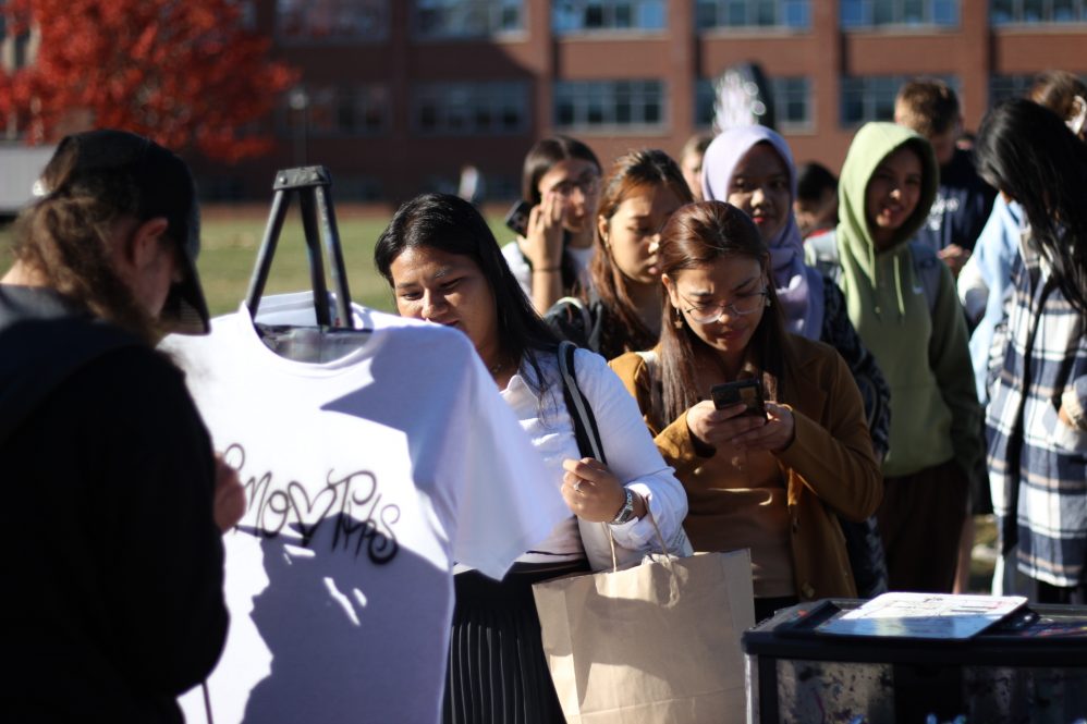 Students line up for t-shirt airbrushing during Homecoming Weekend.