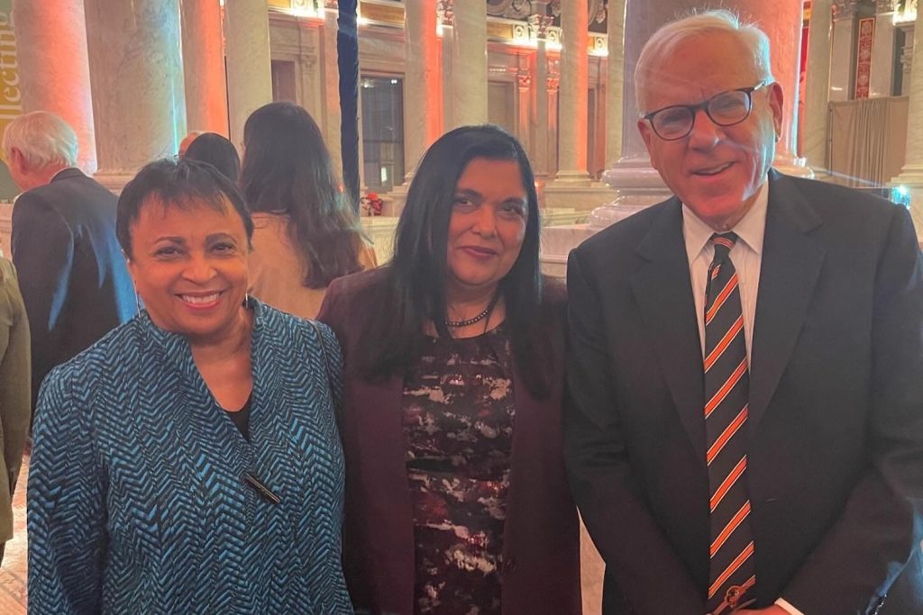 Manisha Sinha poses for a photo with Librarain of Congress Carla Hayden and businessman David Rubenstein.