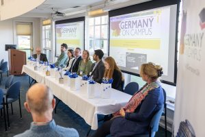 Attendees of the Germany on Campus summit listen to an alumni panel.