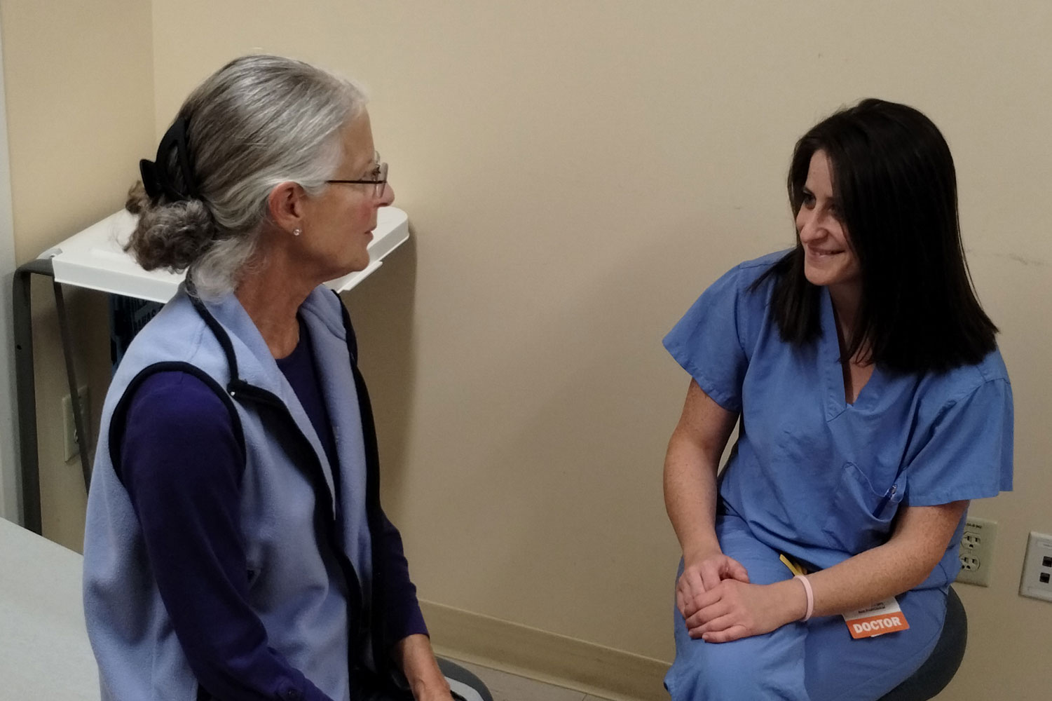 patient and physician speaking in exam room