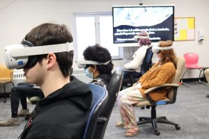 E.O. Smith High School students use a virtual reality exhibit.