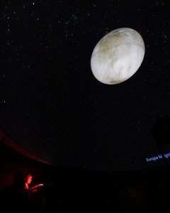 PhD student Kelcey Davis leads a planetarium show about the moons of Jupiter.