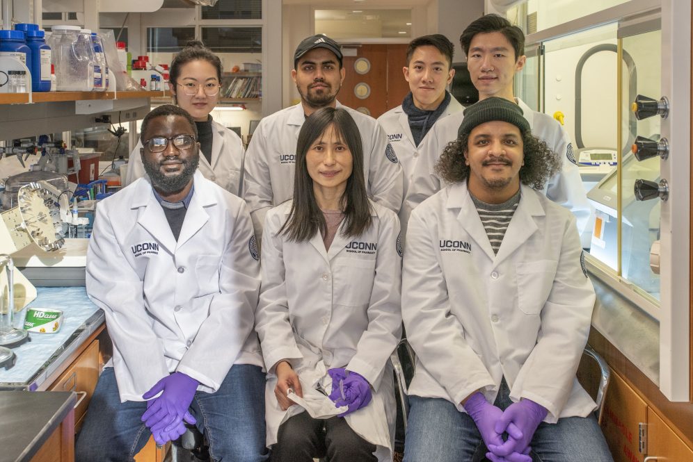 A group of seven individuals in labcoats