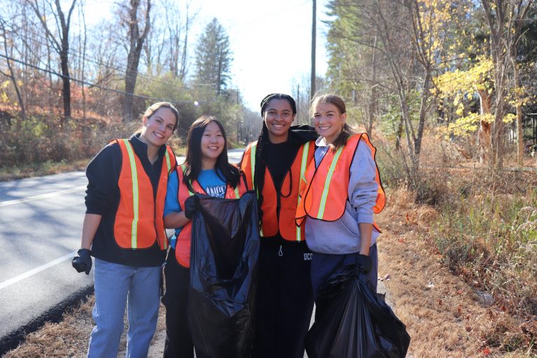 UConn Students collecting trash in Mansfield as part of the 