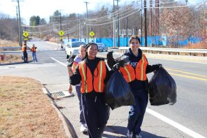 Students collecting trash along North Eagleville Road in Storrs