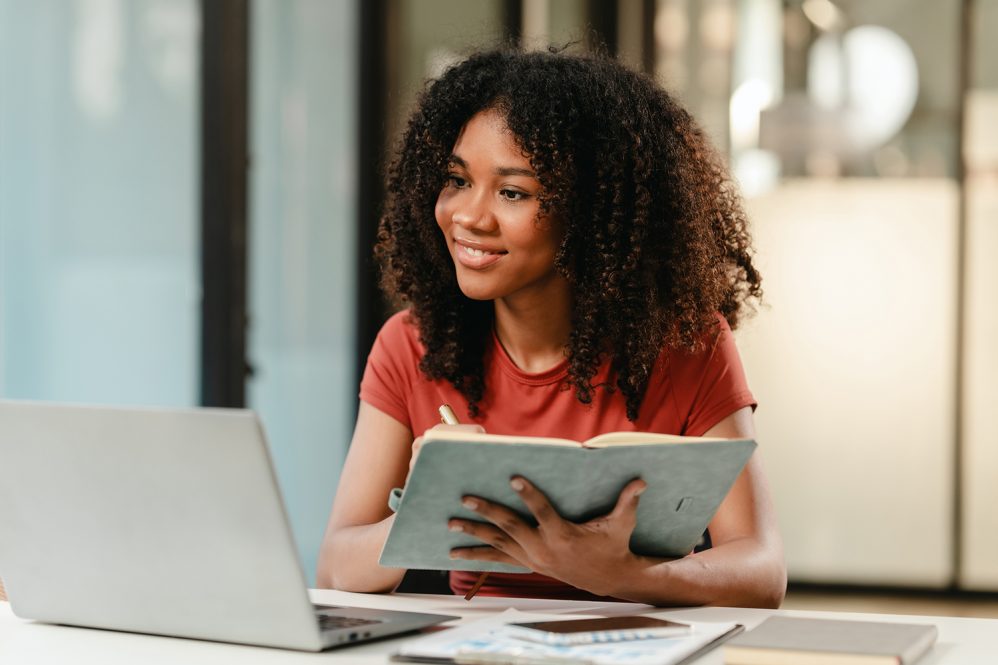 African American Student taking an online class on her laptop